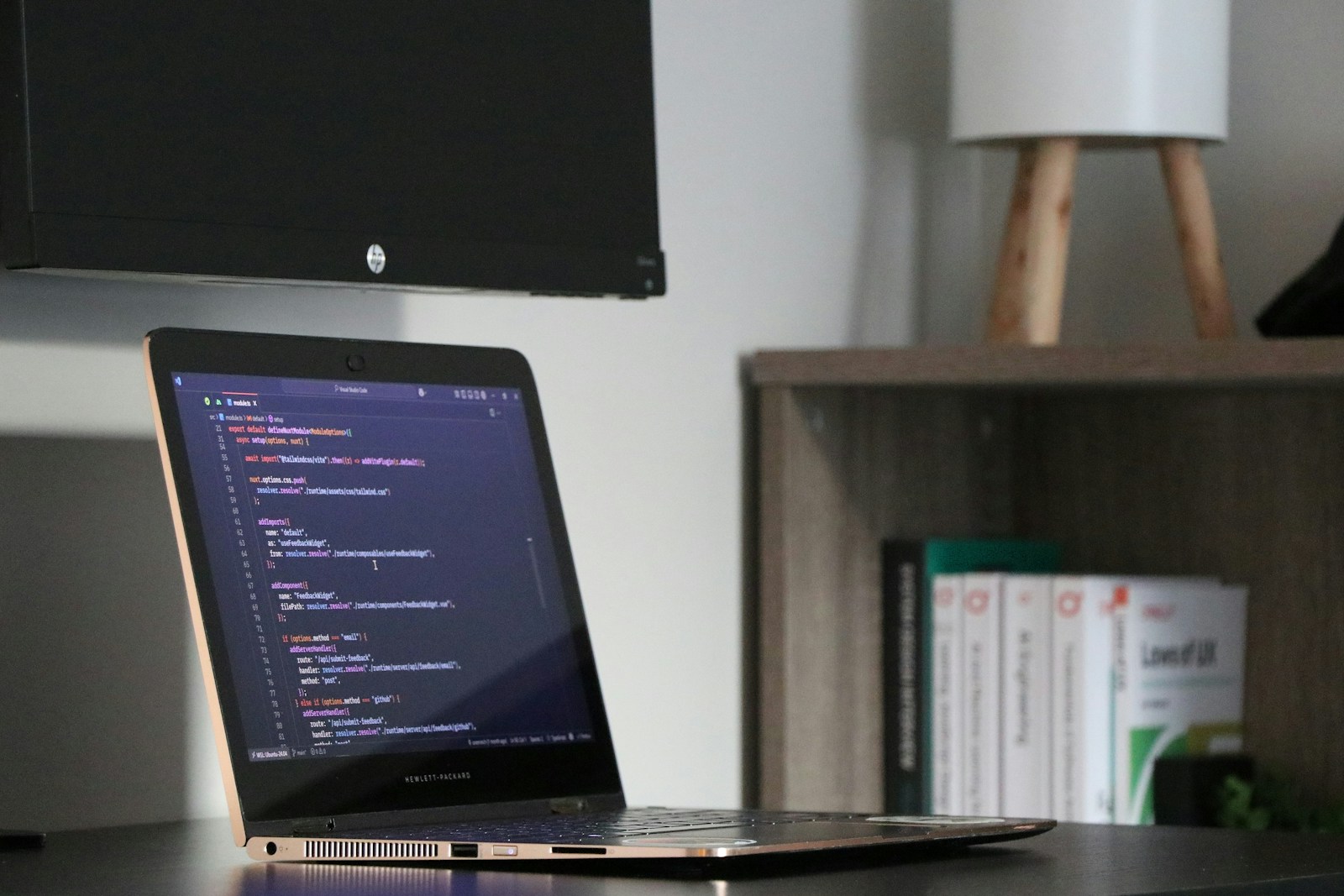 Laptop showing code in a developer workspace